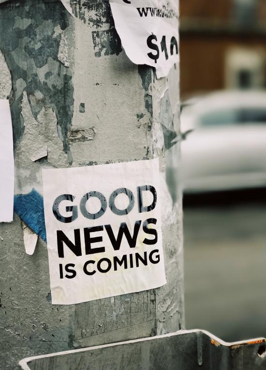 pole with a sticker which reads "good news is coming"